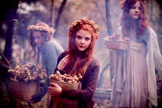 girls holding baskets of flowers