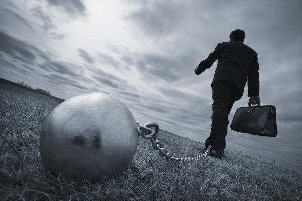 man chained to ball