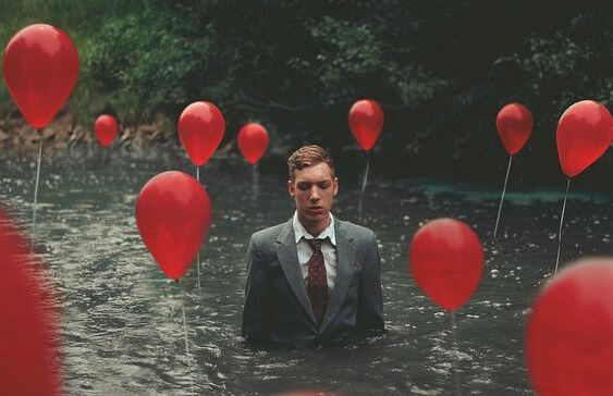 man in water with balloons
