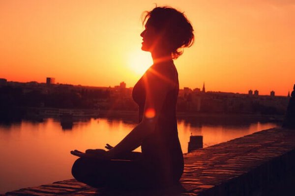 A woman meditating.