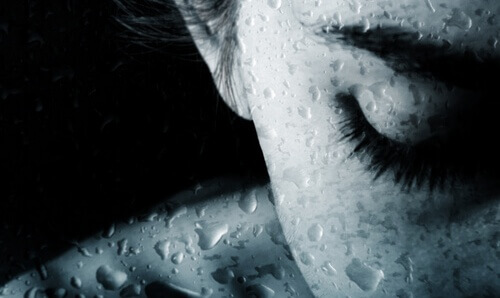 woman behind water droplets