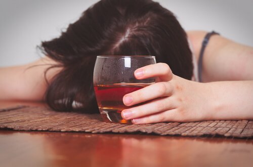 alcoholic-woman-on-the-floor-with-a-glass-of-wine