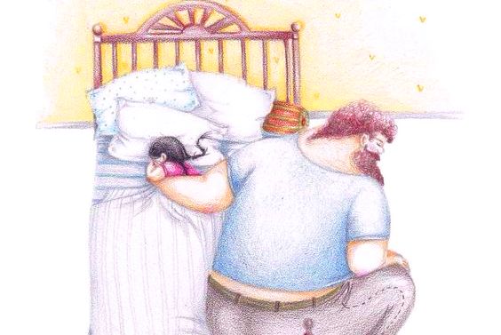 father cuddling daughter