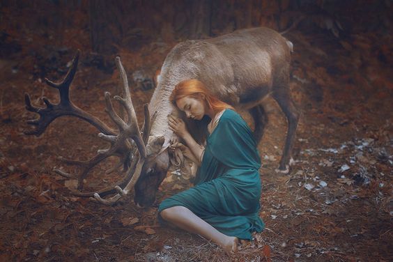 woman hugging deer