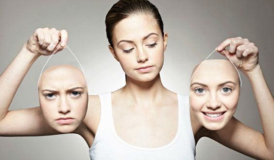 Woman Holding Happy and Mad Faces