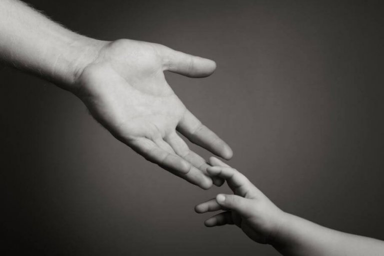 adult holding a child's hand