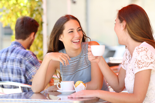 girls drinking coffee and laughing
