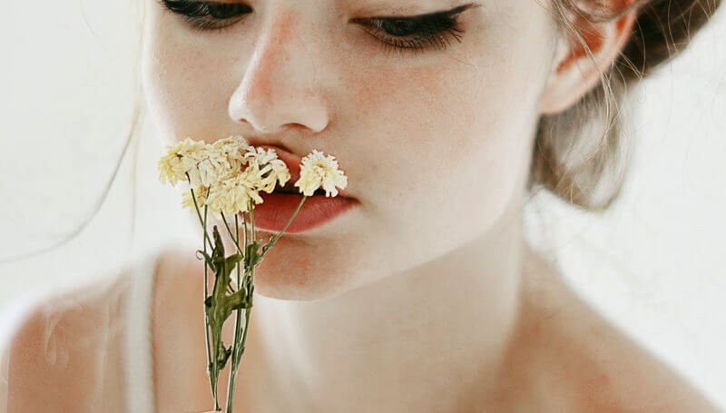 Woman Smelling Flowers