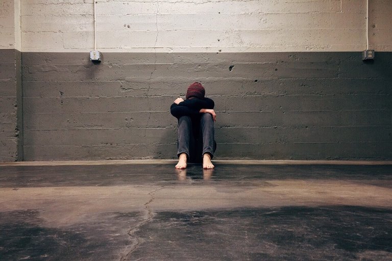 sad person sitting alone