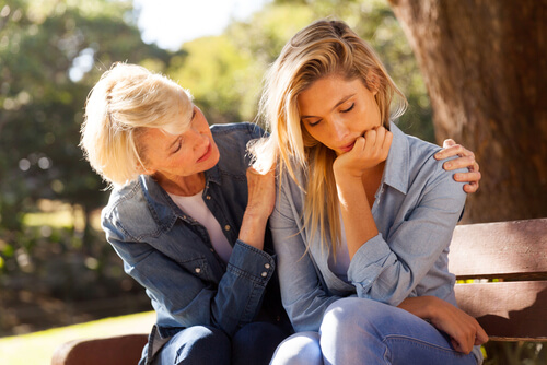 woman comforting another
