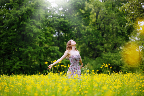 woman in field of flowers