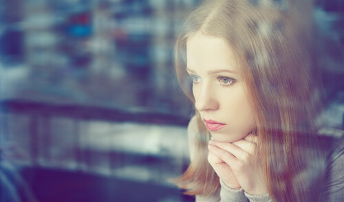 woman looking out window