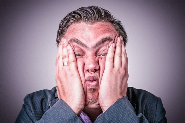 man squishing face