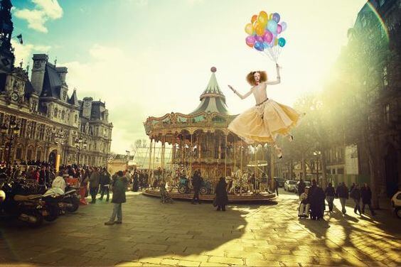 woman floating away balloons