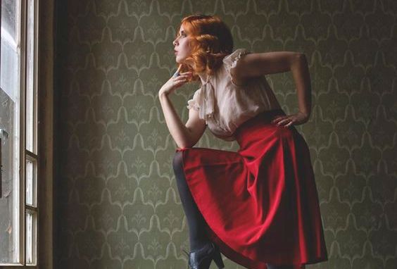 woman posing by window