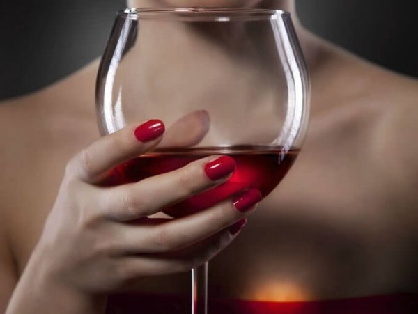 Woman holding a glass of wine.