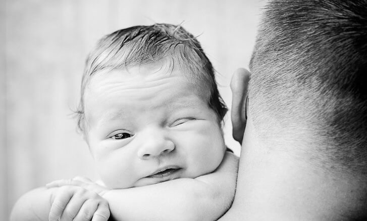 baby on father's shoulder