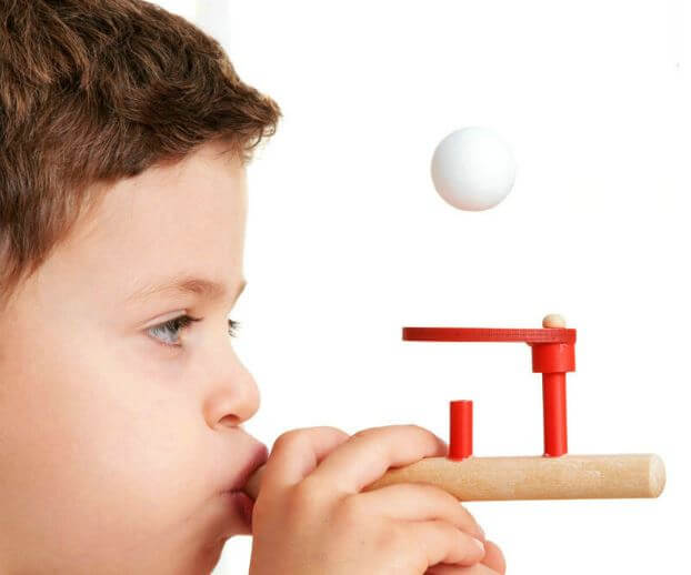 boy blowing on a toy