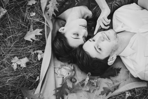 couple laying on a blanket