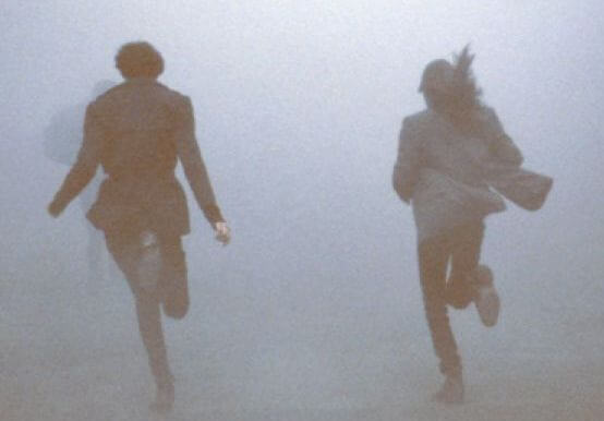 couple running in the mist