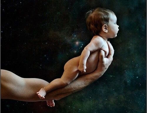 father holding up baby with one arm