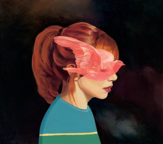 redhaired girl with bird covering face