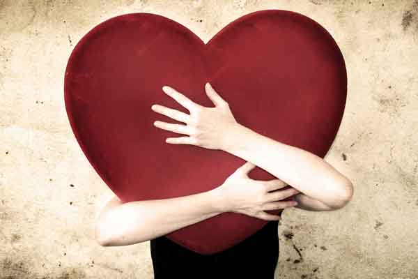 someone hugging giant heart