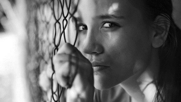 woman grasping fence