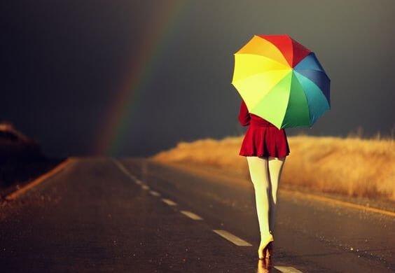 ballerina on street with colorful umbrella