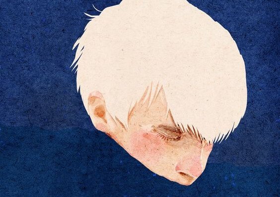 A blonde boy in a blue background.