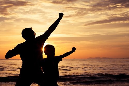 father and son playing on the beach