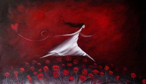 A girl is running through red flowers with a heart on a string.