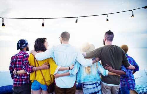 A group of friends is hugging side by side.