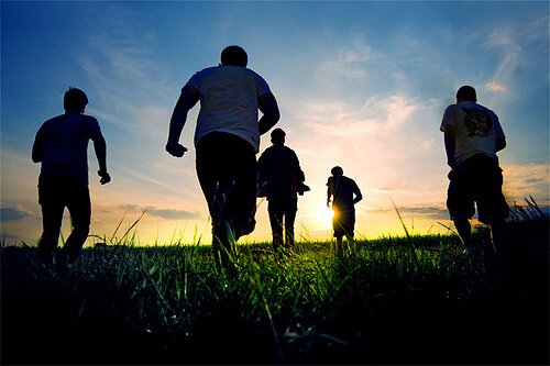 group of friends in a field of grass