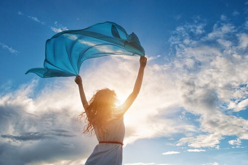 A woman with a scarf on a windy day: not seeking the approval of others.