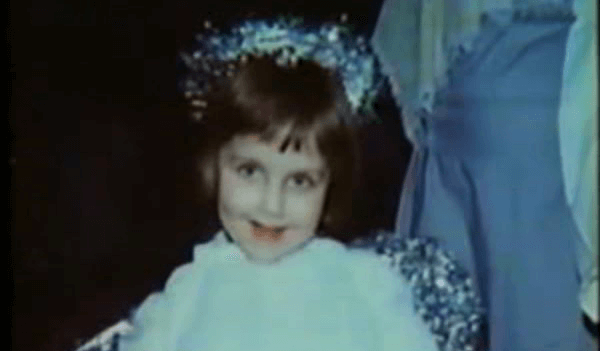 Beth Thomas as a little girl in a dress.