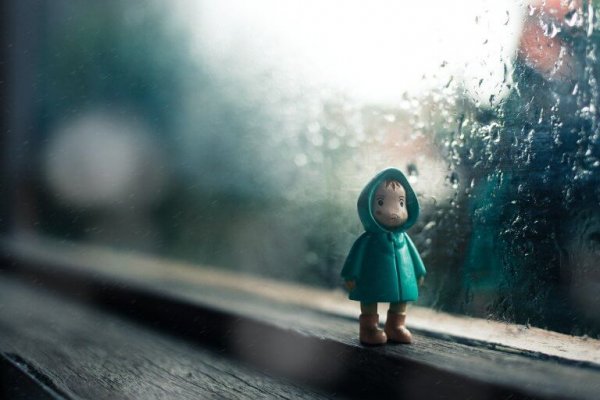 a doll of a child wearing a raincoat