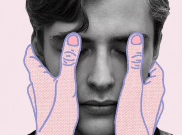 two hands covering a man's eyes