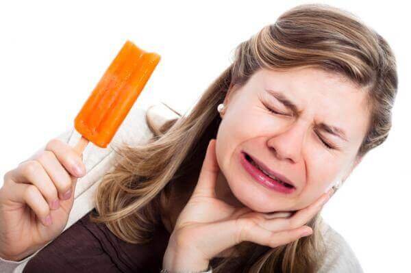 a woman with tooth pain from eating ice cream