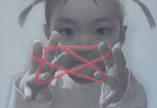 a little girl playing a string game