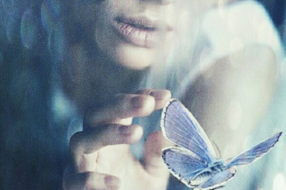 a woman touching a butterfly