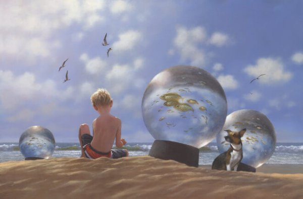 a little boy playing on the beach with a dog and fish in a snowglobe