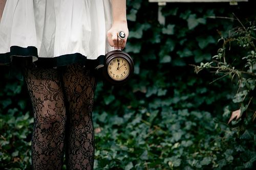 a girl holding a clock