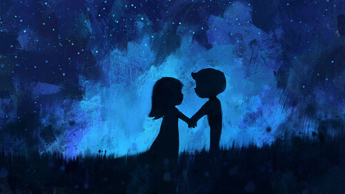 a boy and girl holding hands in a field at night