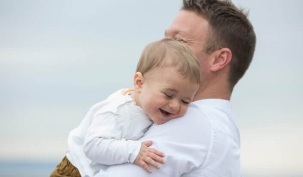 a smiling baby boy with his dad