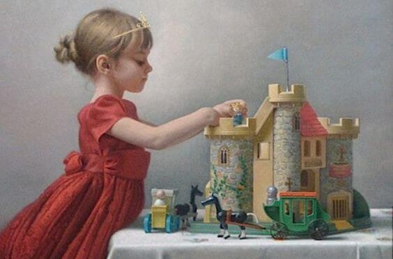 a little girl playing with a castle wearing a tiara