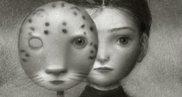 a little girl holding a tiger mask up to her face