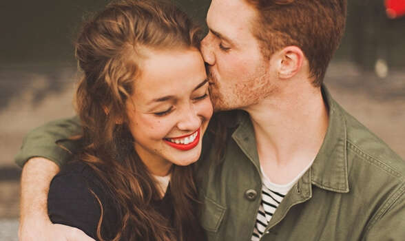 a happy couple, man with his arm around the girl