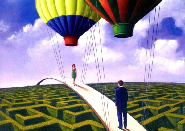 two people on a bridge over a maze with hot air balloons above