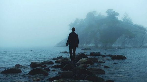 a lone man in a rainy sea